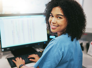 Smiling dental team member working at computer