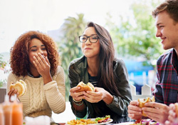 Group of friends eating burgers