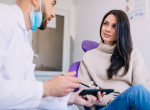 Patient and dentist having a friendly conversation