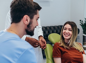 Happy patient talking with her dentist