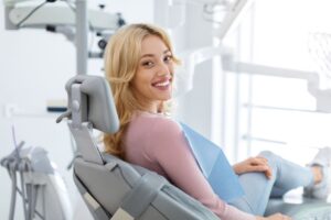 Happy dental patient looking over her shoulder